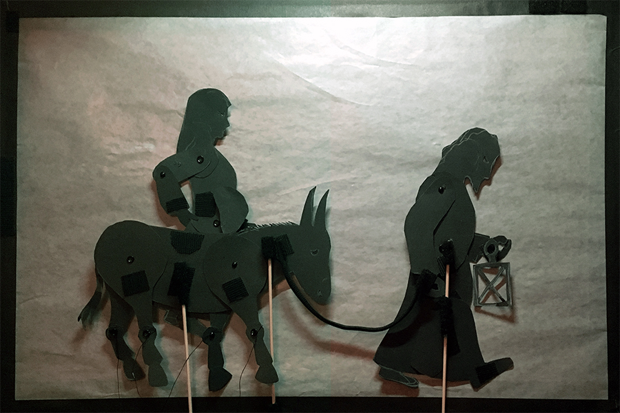 Shadow puppet of Joseph with lantern and pregnant Mary on donkey