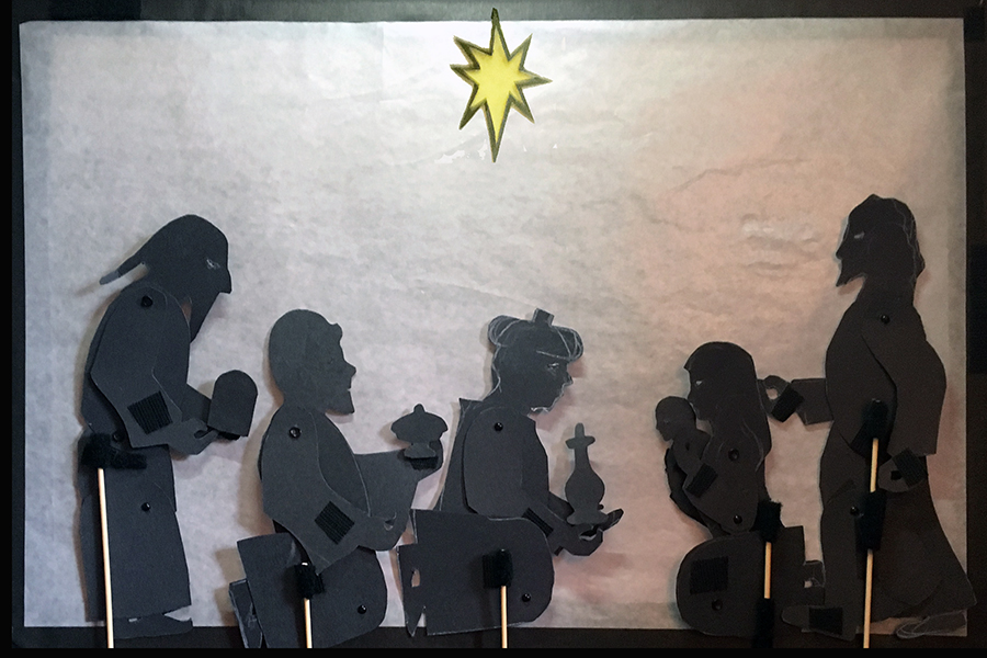 shadow puppet of three magi kneeling before Mary holding Jesus and Joseph