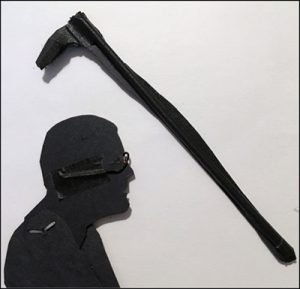 Reverse side of the puppet's head showing how glasses made of wire are taped to the back. The paper cane is supported by a piece of barbecue skewer.