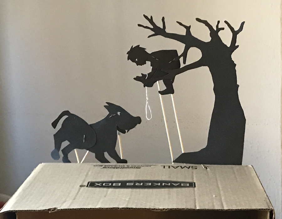 Silhouette puppets of Pet in a tree holding a rope with wolf with rods stuck in the bottom side of a box