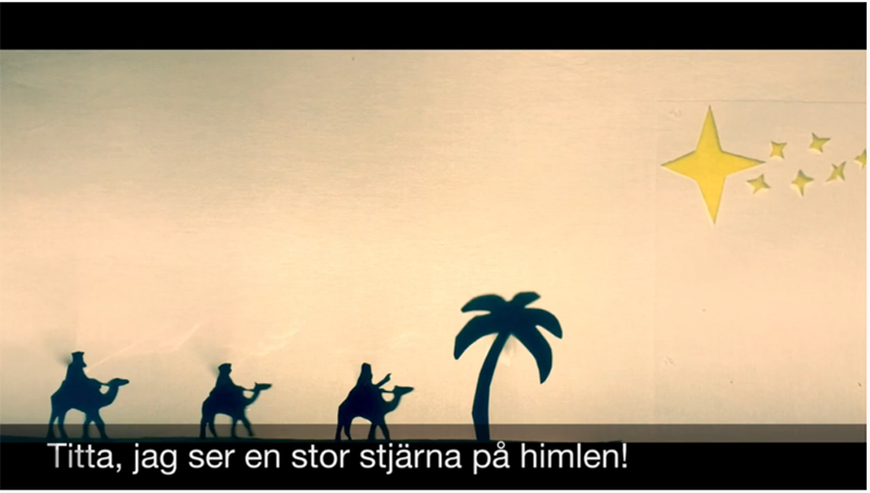 Profiles of three magi on camels with Swedish captioning 