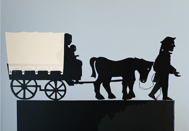 Silhouette puppets showing a man holding the reigns of a horse, which pulls a covered wagon with a woman on the front seat holding a little child.