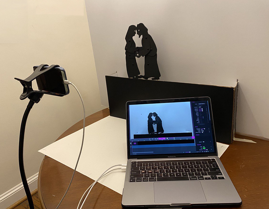 Tripod cell phone holder with laptop and shadow puppets