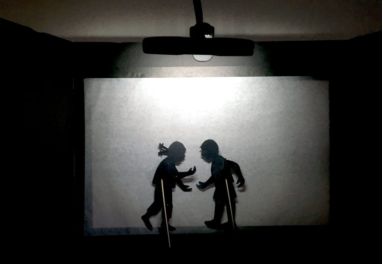 foam board portable screen showing boy and girl puppet
