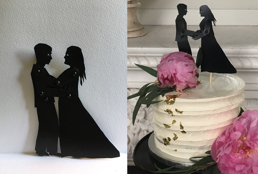 Small shadow puppets holding hands and embracing with wedding cake