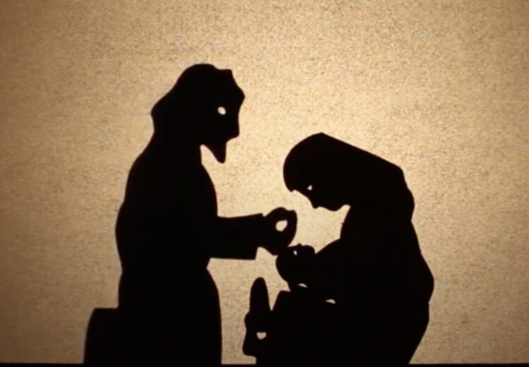 Shadow puppets of Mary holding Jesus and Joseph caressing his head