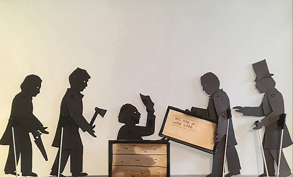 Shadow puppets of Henry "Box" Brown coming out of the box surrounded by William Still and his friends in 1849, based on an illustration used in William Still's book "The Underground Railroad"